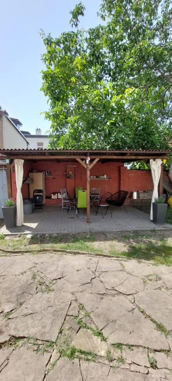 a pavilion with a table and chairs on a patio at Ferienwohnung am Bahnhof in Bernburg
