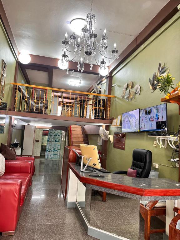 a waiting room with a desk with a laptop at Yuma Tashi Hostel in Bangkok