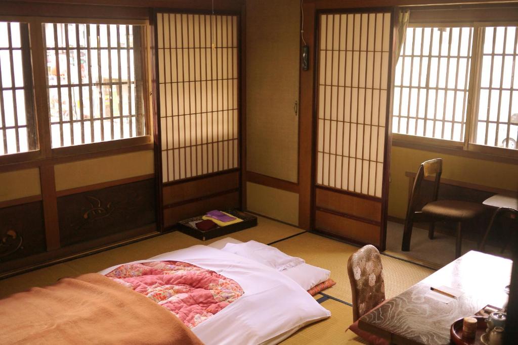 Postel nebo postele na pokoji v ubytování Ryokan Kaminaka