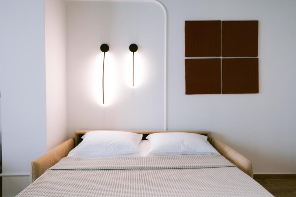 Postel nebo postele na pokoji v ubytování Noemie Hotel