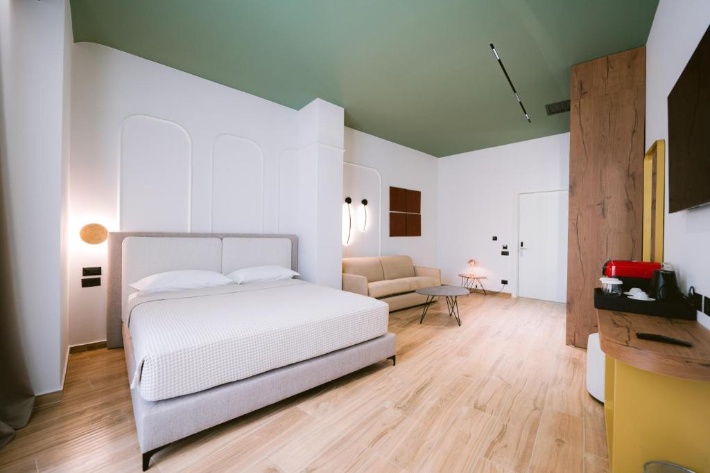 Postel nebo postele na pokoji v ubytování Noemie Hotel