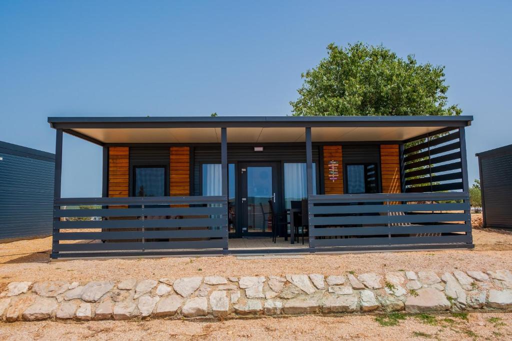 a modern house with a glass facade at Mobile Homes Pirovac with 2 shared Pools in Pirovac