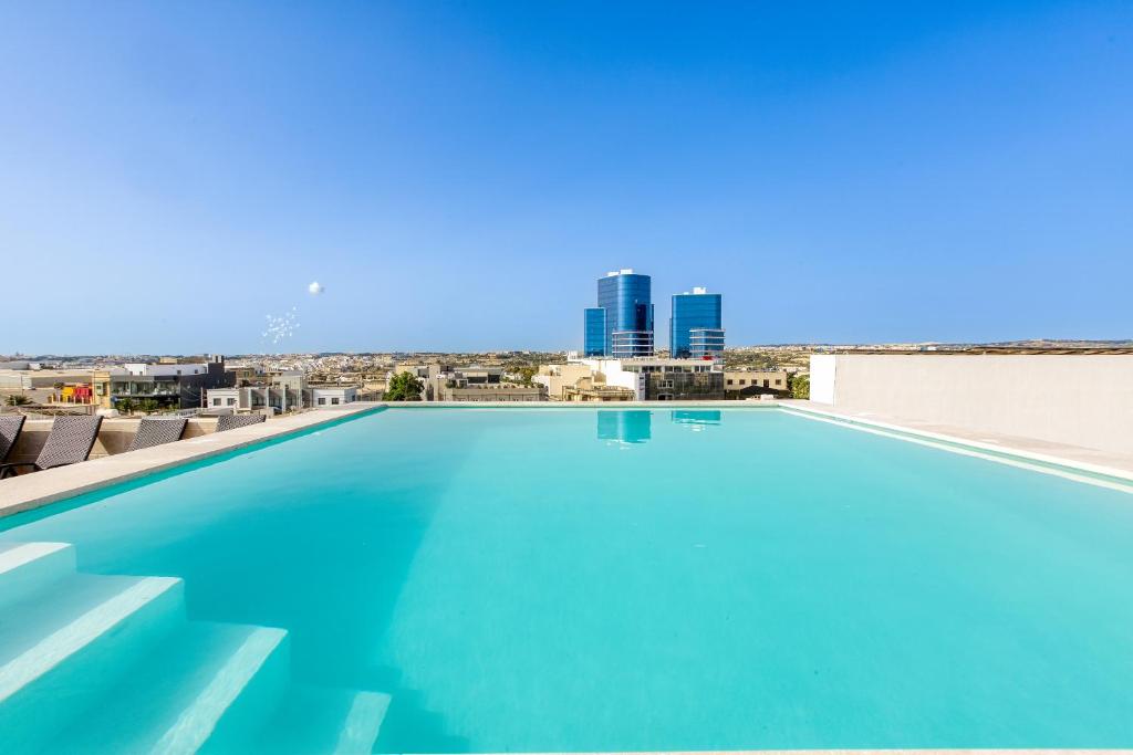 a swimming pool with a view of the city at Annitchka Mansions - Apartment in central Malta in Birkirkara