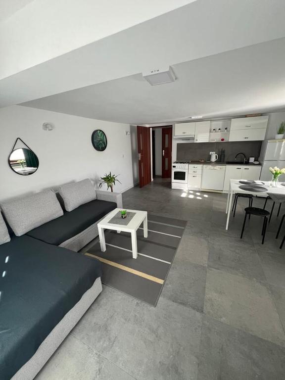 a living room with a couch and a table at Apartament Koninki in Poręba Wielka