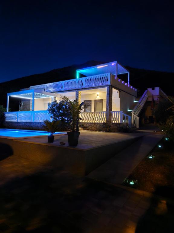a building with blue lights on it at night at Apartman Lidija in Starigrad