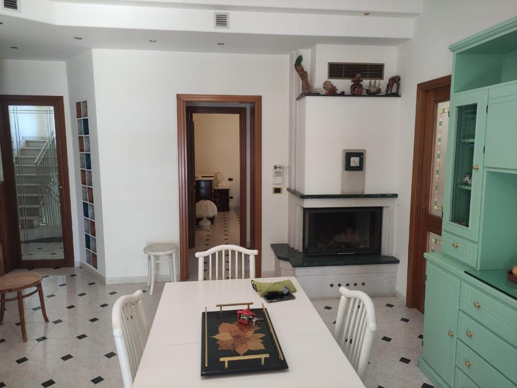 a kitchen with a table and chairs and a fireplace at Al mare da Merida in Savelletri di Fasano