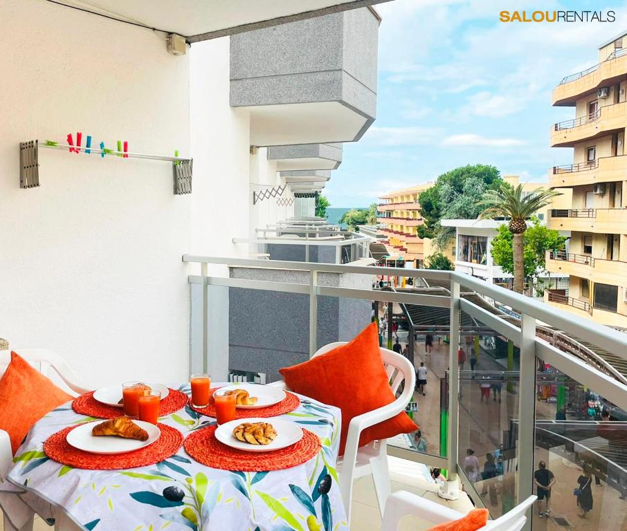 a balcony with a table with plates of food on it at Blue Sky Barbastre - Salou Centre in Salou