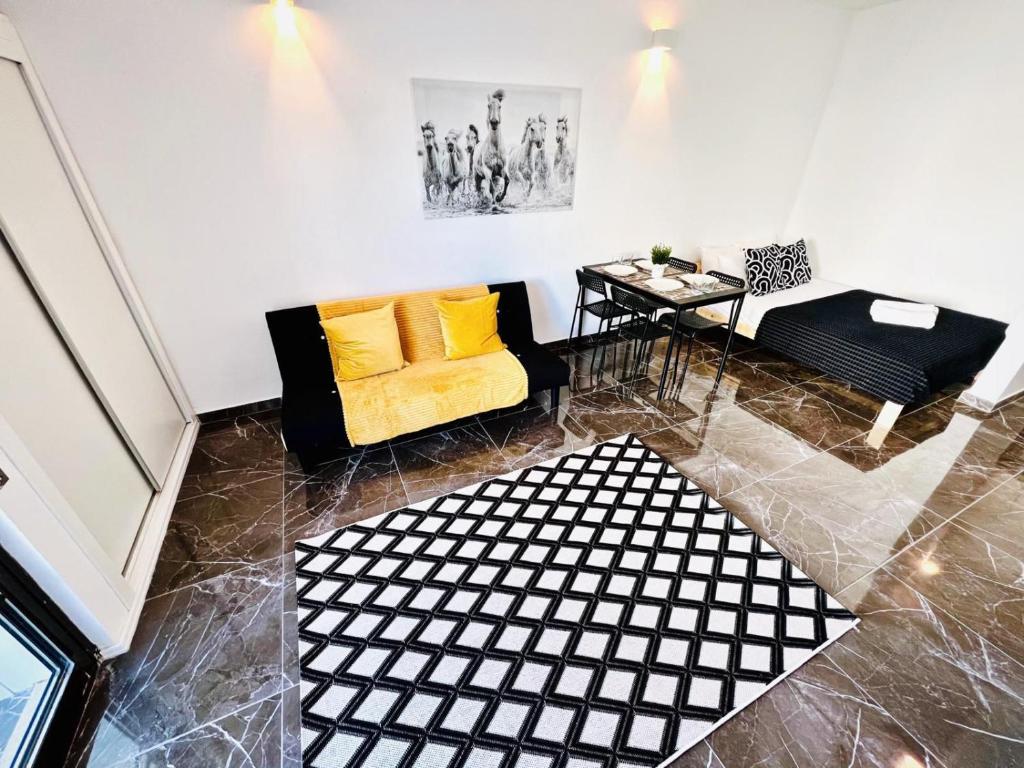 a living room with a yellow couch and a table at Flat Luxuous Praia da Oura in Albufeira