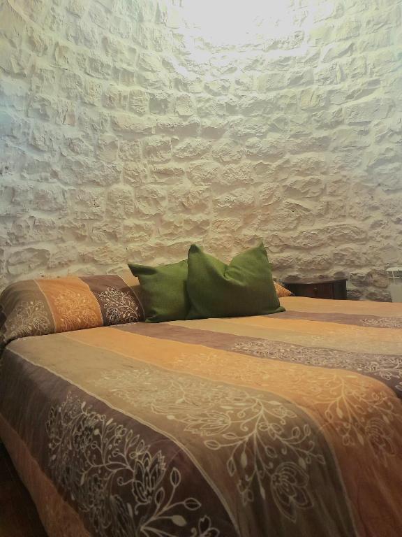 Posteľ alebo postele v izbe v ubytovaní La Rosa dei Trulli B&B