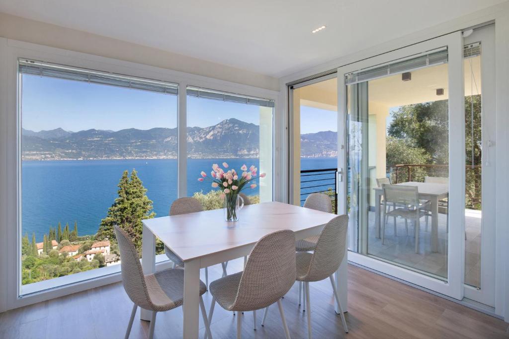 a dining room with a table and chairs with a view of the ocean at Paradise Apartment With Pool in Pai