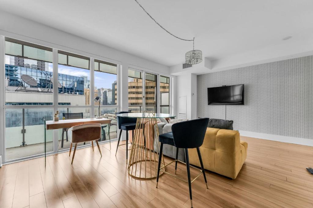 a living room with a couch and a table and chairs at Estate 1 Bedroom Condo Front Street West in Toronto