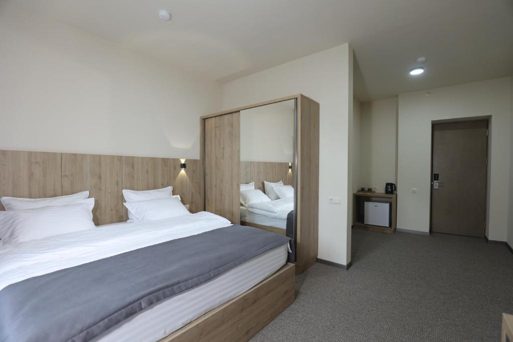 Postel nebo postele na pokoji v ubytování Cone Hotel