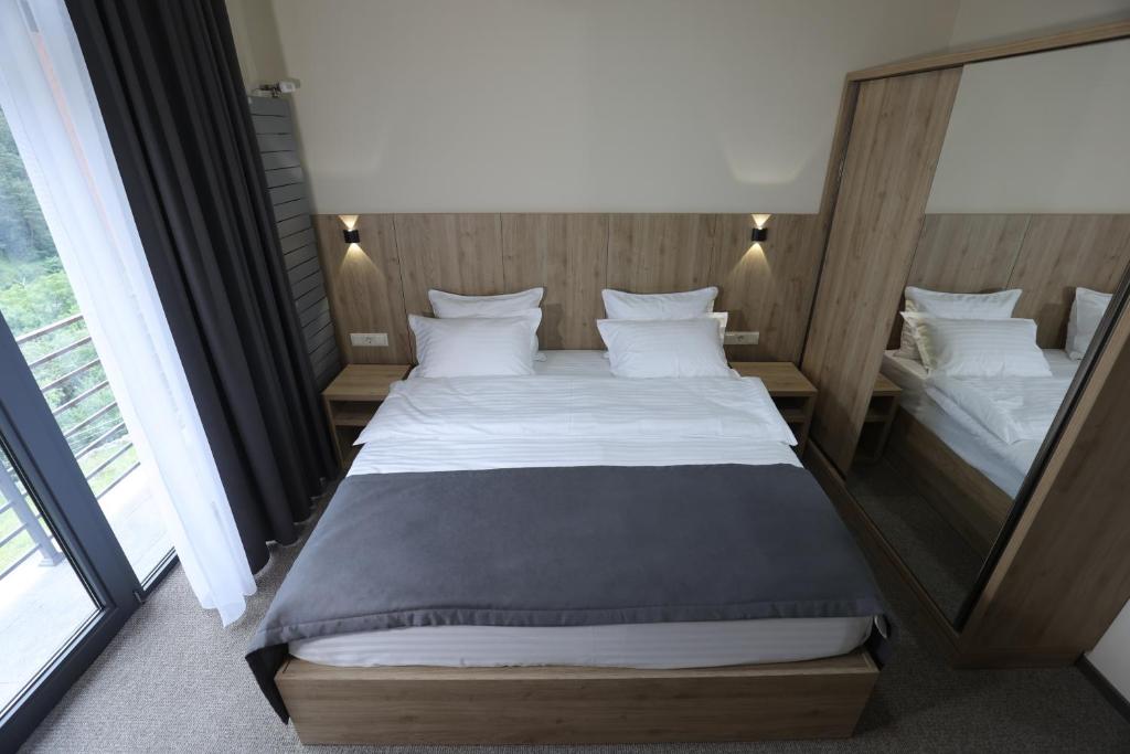 Postel nebo postele na pokoji v ubytování Cone Hotel