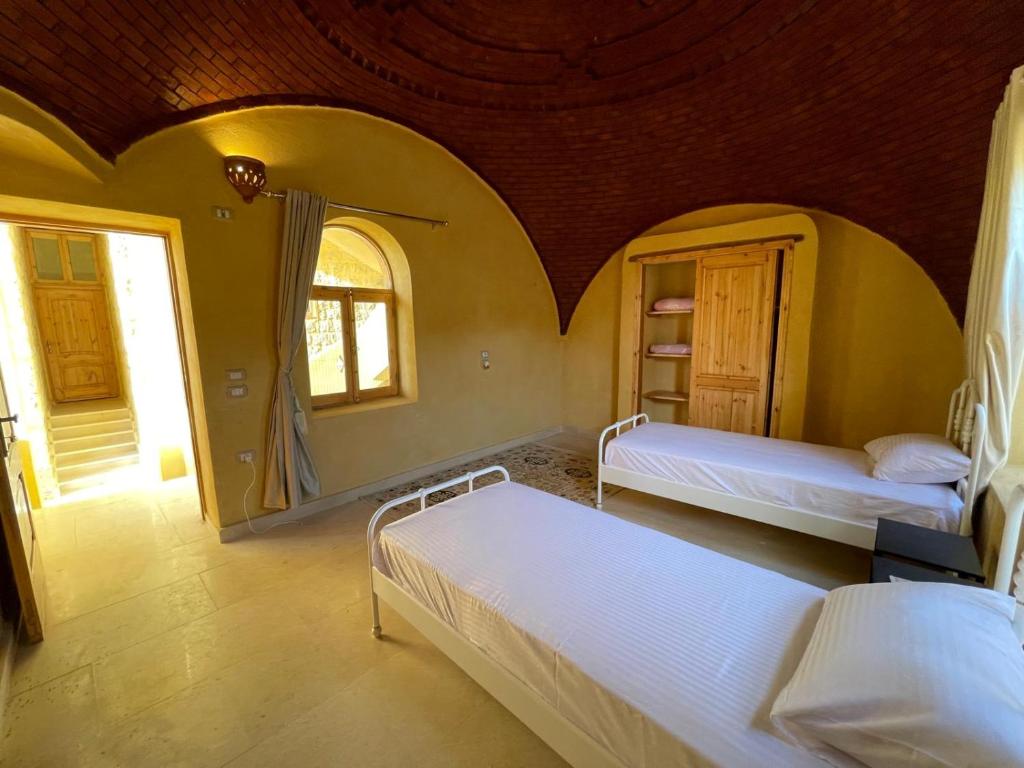 Postel nebo postele na pokoji v ubytování Hoopoe lodge