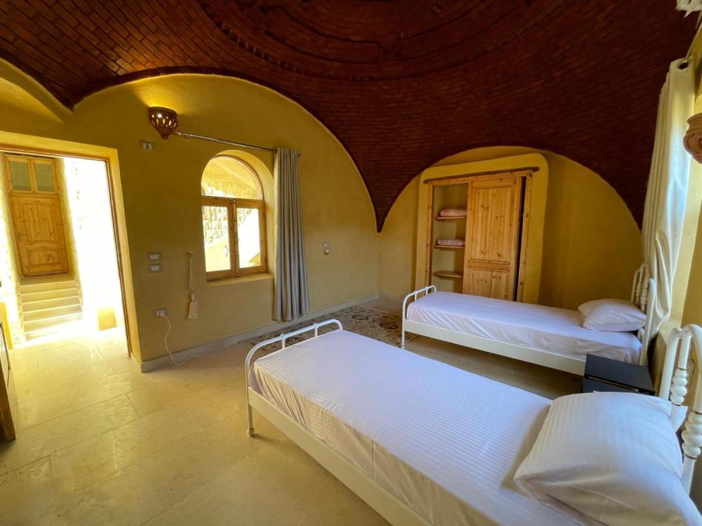 Postel nebo postele na pokoji v ubytování Hoopoe lodge