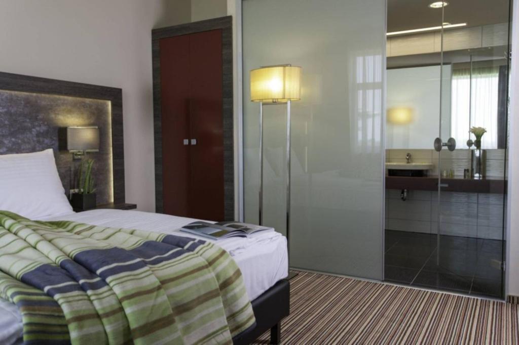Posteľ alebo postele v izbe v ubytovaní ETO Park Hotel Business & Stadium