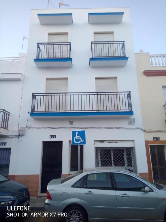 a car parked in front of a building at Pisos Isla Cristina 1 in Isla Cristina
