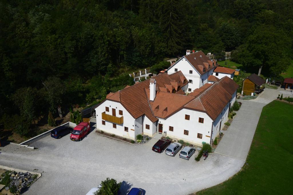 an overhead view of a large house with cars in a parking lot at Pension Kadlcuv Mlyn in Brno
