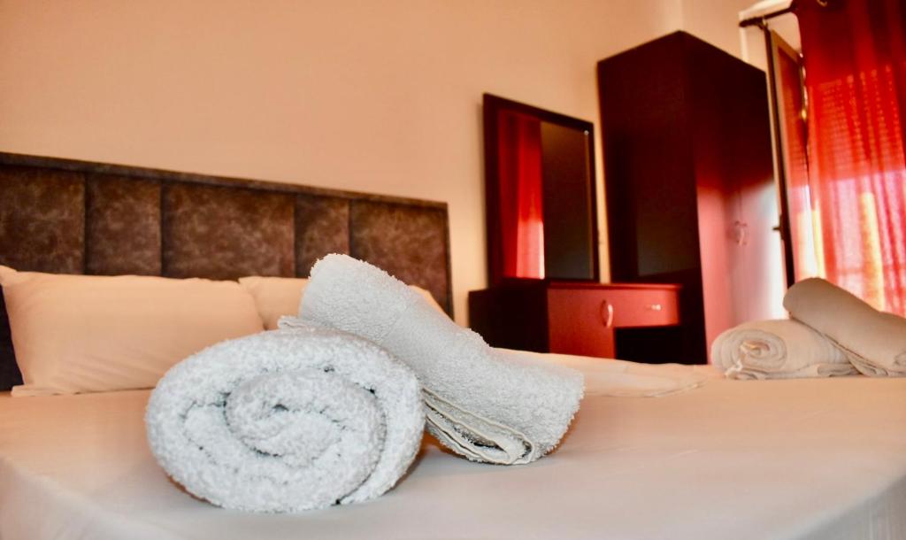 a hotel room with a towel on a bed at Vila Llaka in Himare