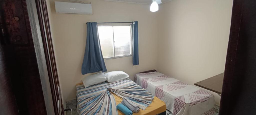 Ένα ή περισσότερα κρεβάτια σε δωμάτιο στο Arraial Hospedagens
