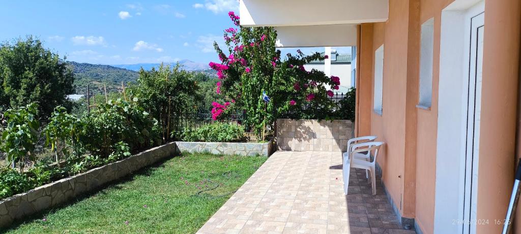 a white chair sitting on a porch of a house at La casa di Voula in Néa Seléfkeia