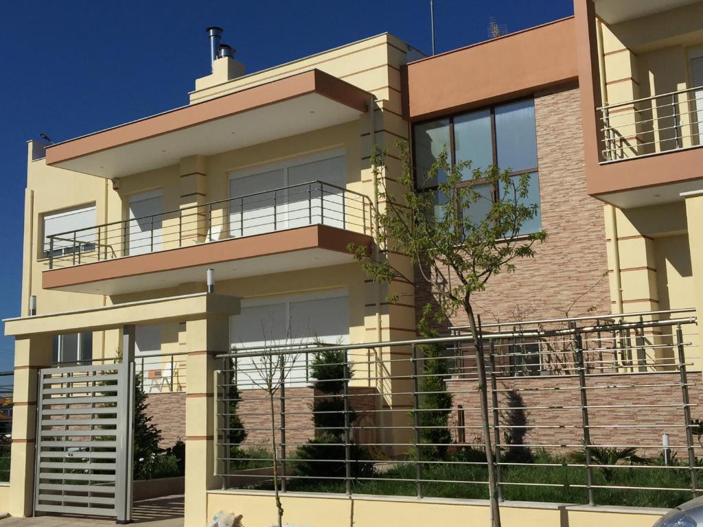 a house with balconies on the side of it at Efrosinis home in Néa Michanióna