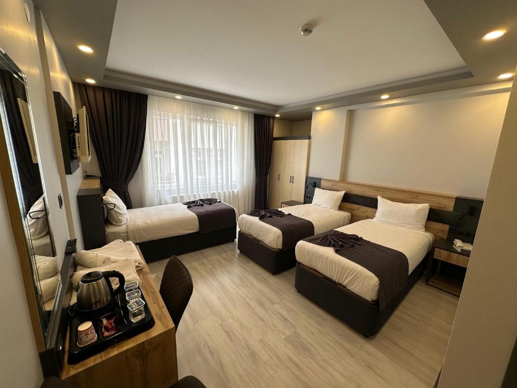 Postel nebo postele na pokoji v ubytování Ofpark Otel