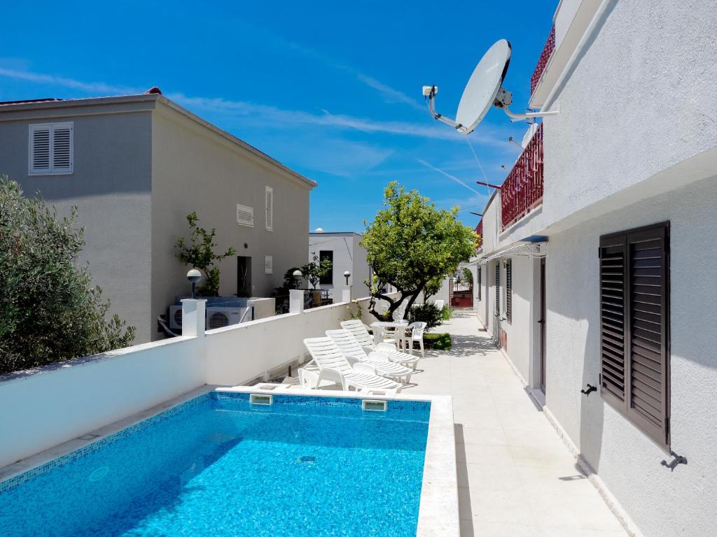 a swimming pool on the side of a house at Villa M&M - ZF Hvar in Hvar