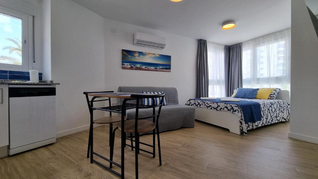 a bedroom with a bed and a table in a room at Diana Playa in Benalmádena