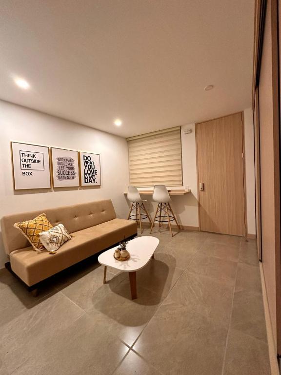 a living room with a couch and a table at Belmonte Studio 311 in Armenia
