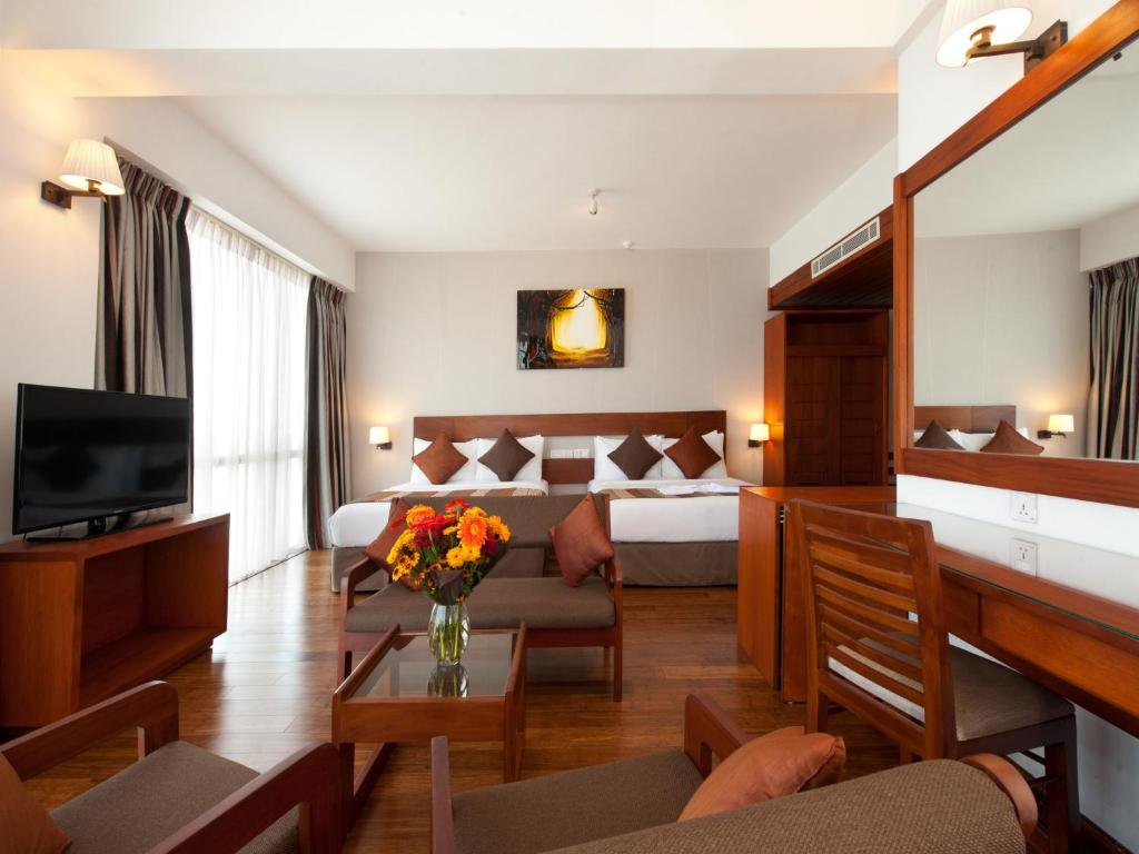 Postel nebo postele na pokoji v ubytování The Ocean Colombo