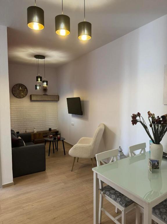 a living room with a couch and a table at Malvina Homes Knossou in Áno Fortétsa