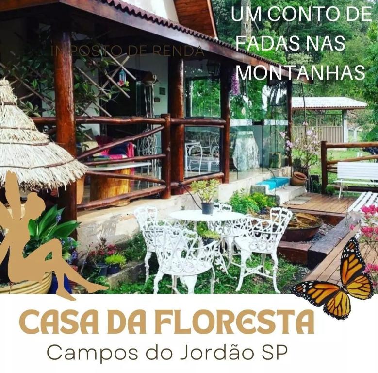 a sign for a restaurant with a butterfly on it at Casa dentro da floresta in Campos do Jordão