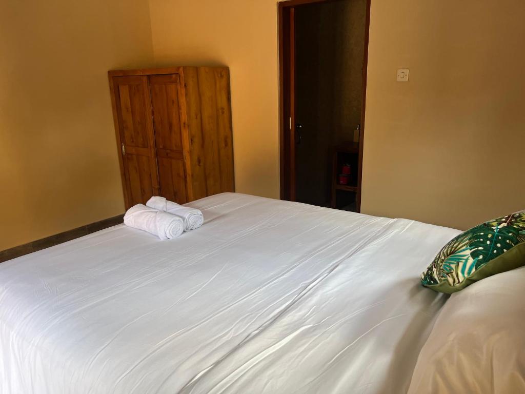 Postel nebo postele na pokoji v ubytování Ananda House