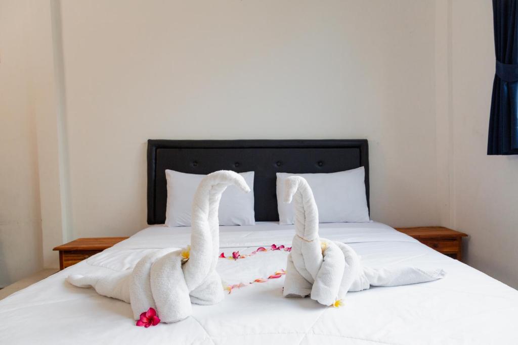 Postel nebo postele na pokoji v ubytování Suardana Inn's