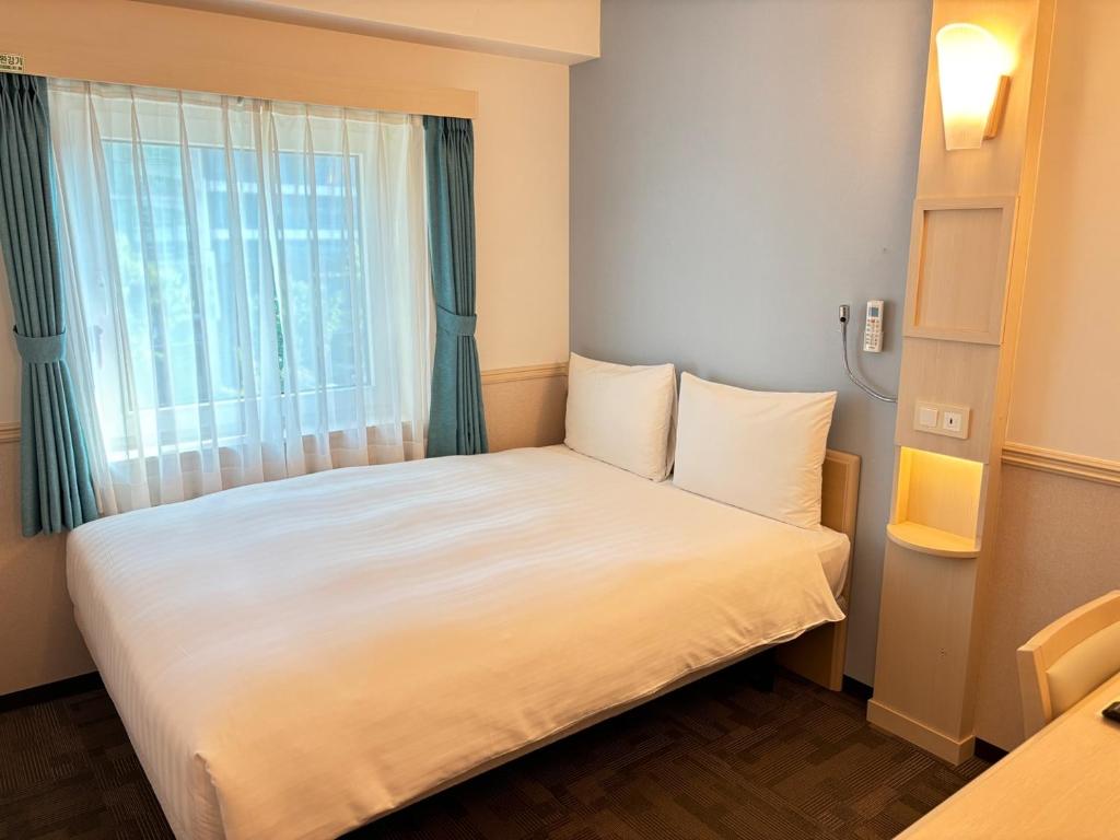 Postel nebo postele na pokoji v ubytování Toyoko Inn Ulsan Samsan