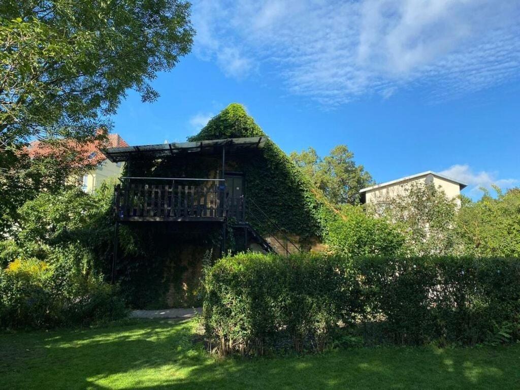 a house with a balcony in the middle of a yard at Mahlau Comfortable holiday residence in Waren