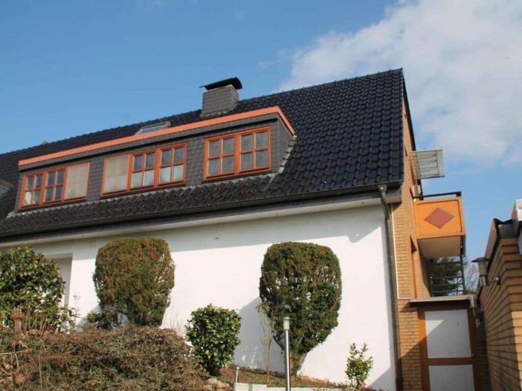 a white house with a black roof at Wehner Comfortable holiday residence in Marl
