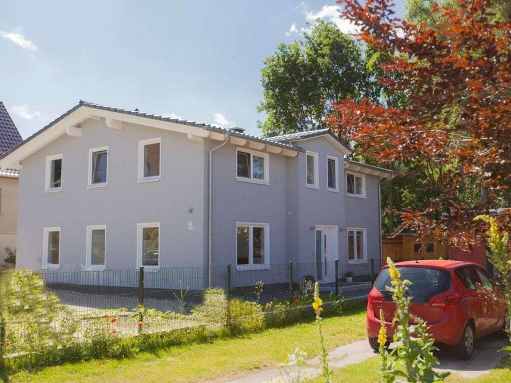 a house with a red car parked in front of it at 1 - Eilrich Comfortable holiday residence in Thiessow