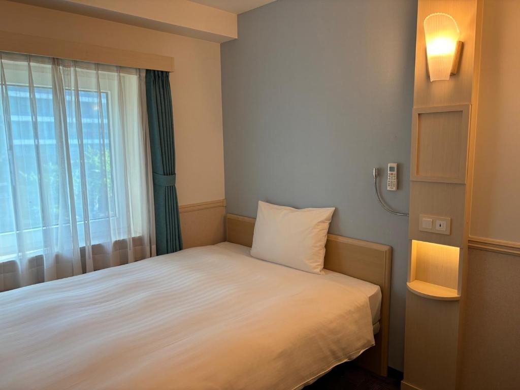 Postel nebo postele na pokoji v ubytování Toyoko Inn Ulsan Samsan