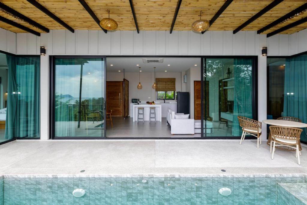 an open patio with glass doors and a table at 2br Seaview pool villa B in Hinkong