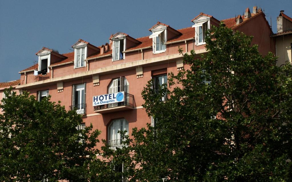 a building with a hotel sign on the side of it at Hotel le Dauphin in Ajaccio