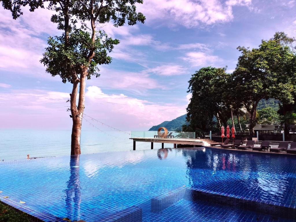 a swimming pool with a tree in the water at Chang Buri Resort & Koh Chang Hillside in Ko Chang