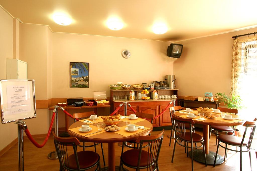 a restaurant with two tables and chairs with food on them at Hotel le Dauphin in Ajaccio