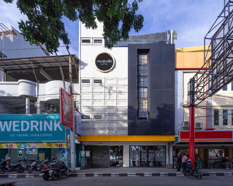 a building with motorcycles parked in front of it at My Studio Hotel Losari Makassar in Makassar
