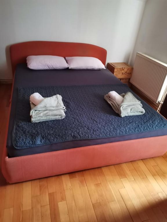 a bed with two pillows and towels on it at Parovic in Nevesinje