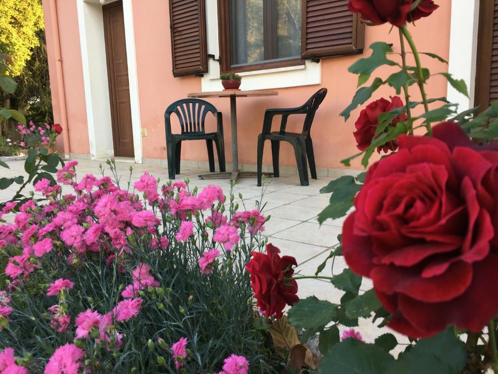 two chairs and flowers in front of a house at Ηρεμία - Φύση in Kastanéa