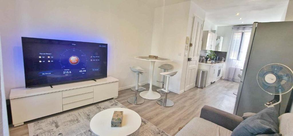 un salon avec une grande télévision à écran plat dans l'établissement Cosy Appart - proche mer et toute commodités, à Nice