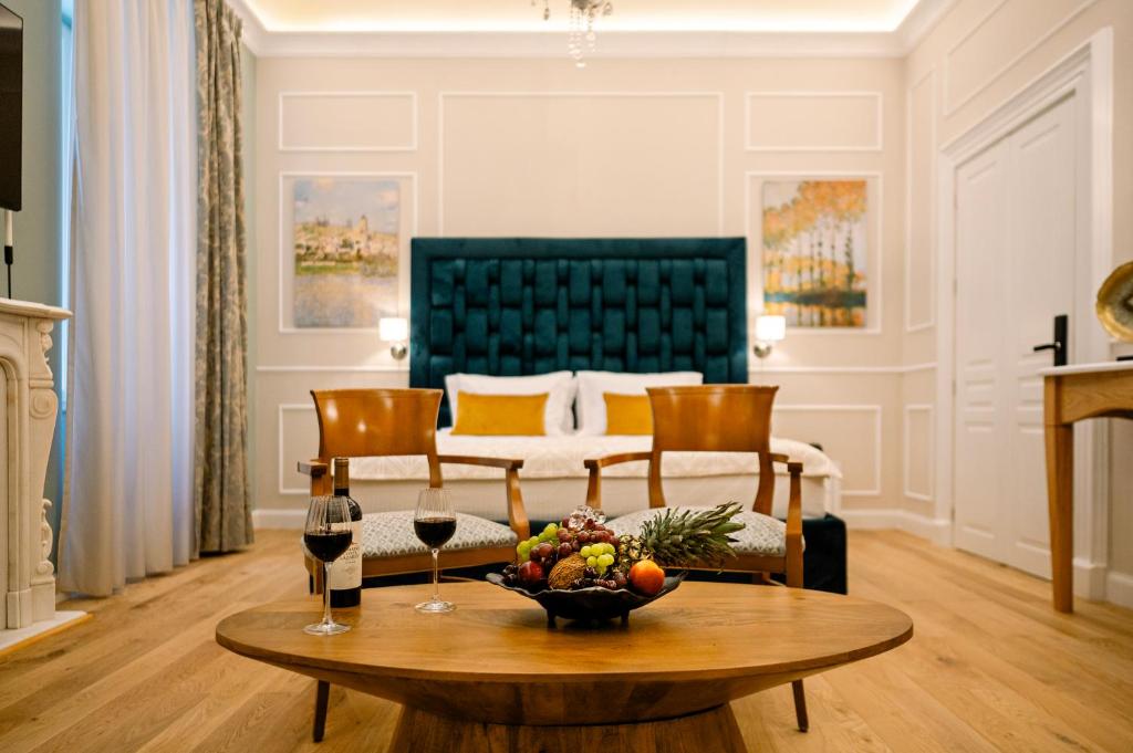 a living room with a coffee table and a bed at Curcumelli Luxury Suites in Corfu Town