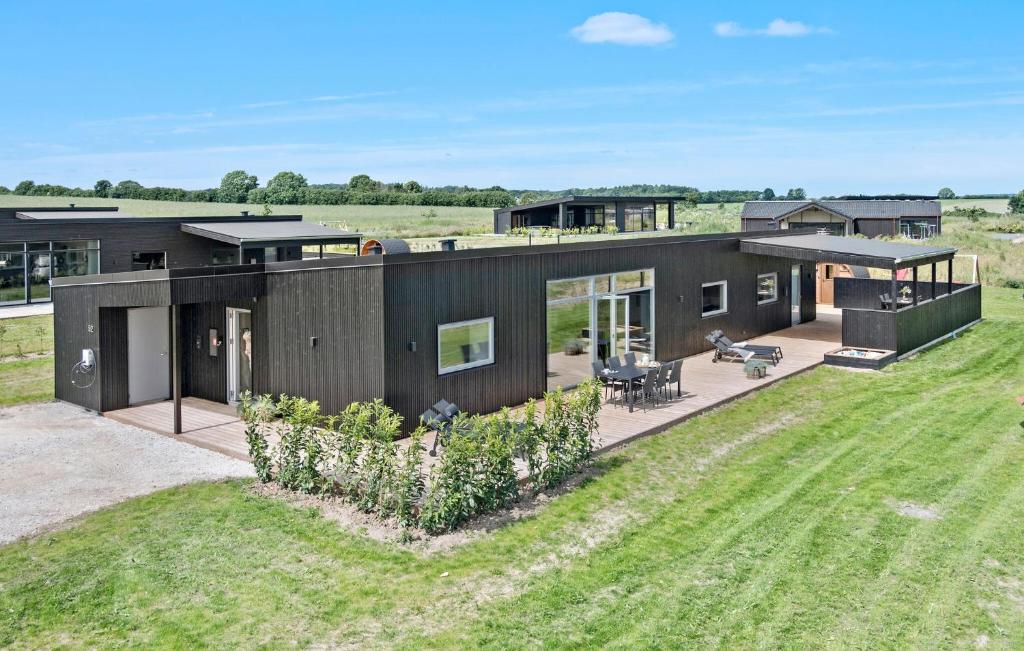 an image of a black house with a yard at Cozy Home In Børkop With Sauna in Børkop